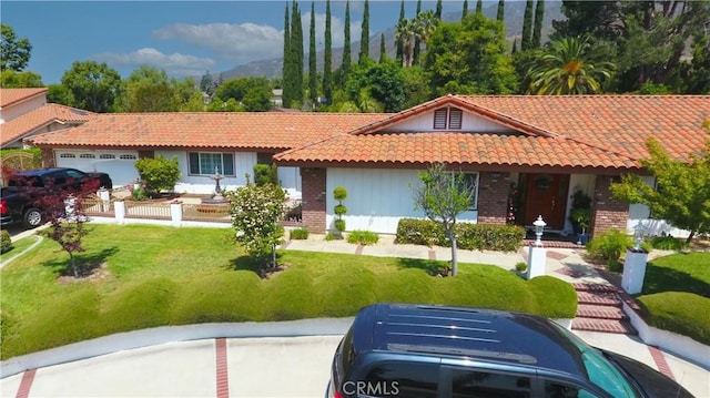 2509 Euclid E, Upland, CA 91784 - view of front facade with brick siding, a tile roof, an attached garage, and a front yard