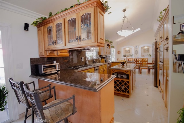 2509 Euclid E, Upland, CA 91784 - kitchen with a peninsula, tasteful backsplash, stainless steel appliances, glass insert cabinets, and hanging light fixtures