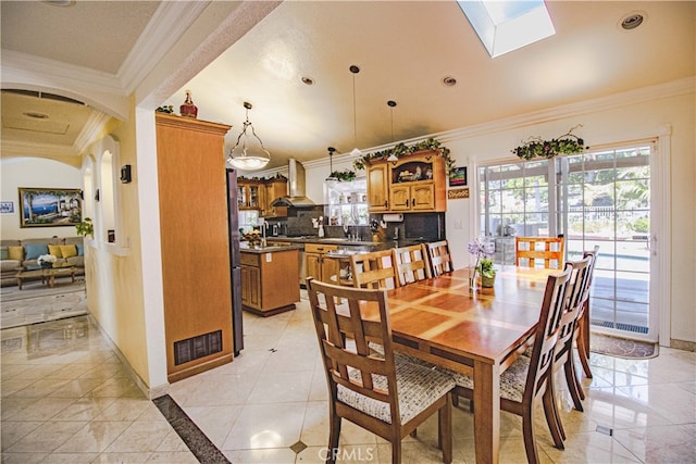 2509 Euclid E, Upland, CA 91784 - dining space with ornamental molding, a skylight, light tile patterned flooring, recessed lighting, and arched walkways