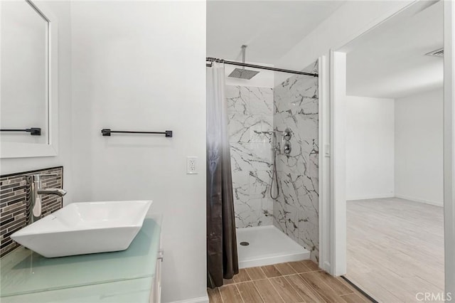 7573 Cibola Trl, Yucca Valley, CA 92284 - full bath with a marble finish shower, wood finish floors, and vanity