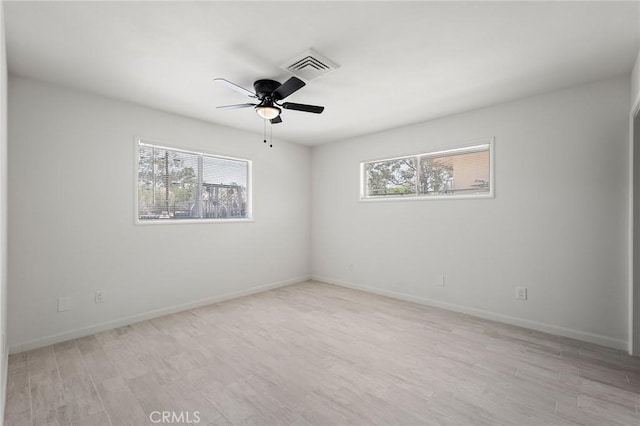 7573 Cibola Trl, Yucca Valley, CA 92284 - unfurnished room featuring plenty of natural light, light wood finished floors, and a ceiling fan