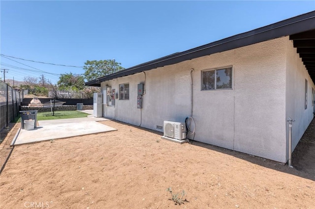 7573 Cibola Trl, Yucca Valley, CA 92284 - view of side of home featuring a fenced backyard, a patio area, and stucco siding