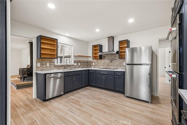 7573 Cibola Trl, Yucca Valley, CA 92284 - kitchen with appliances with stainless steel finishes, wall chimney range hood, open shelves, light countertops, and backsplash