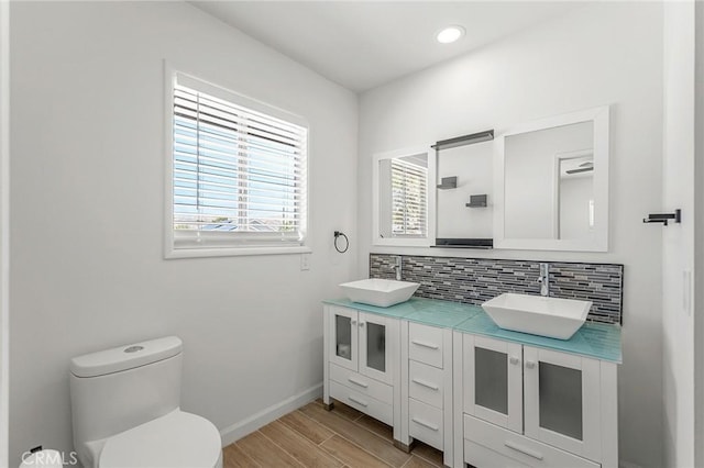 7573 Cibola Trl, Yucca Valley, CA 92284 - bathroom featuring double vanity, backsplash, wood finished floors, and recessed lighting