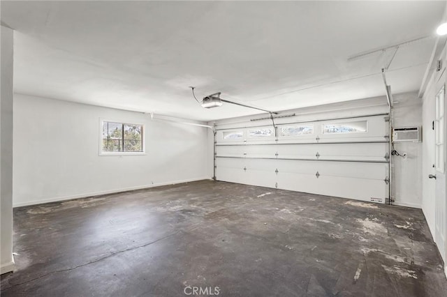 7573 Cibola Trl, Yucca Valley, CA 92284 - garage featuring a wall unit AC and a garage door opener