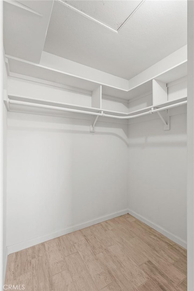 7573 Cibola Trl, Yucca Valley, CA 92284 - walk in closet featuring wood finished floors