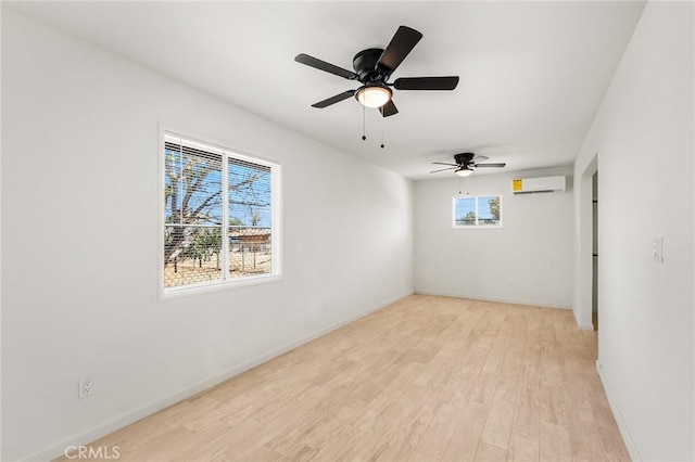 7573 Cibola Trl, Yucca Valley, CA 92284 - spare room featuring a wall mounted AC, light wood-style flooring, and a ceiling fan