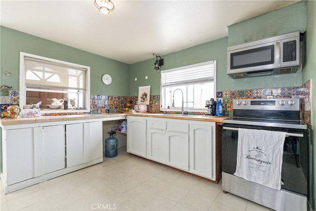 971 Ramona Ave, Los Osos, CA 93402 - kitchen featuring appliances with stainless steel finishes, white cabinets, and healthy amount of natural light