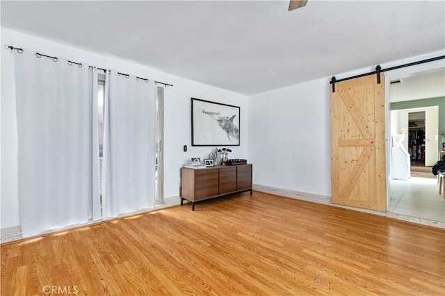 971 Ramona Ave, Los Osos, CA 93402 - bedroom with light wood-type flooring and a barn door