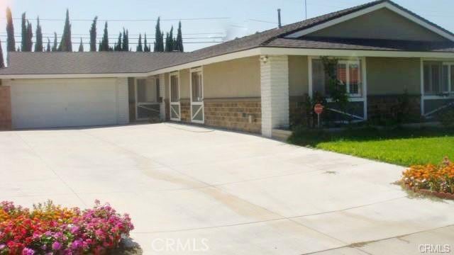 20982 Divonne Dr, Walnut, CA 91789 - view of front facade featuring a garage, concrete driveway, and brick siding