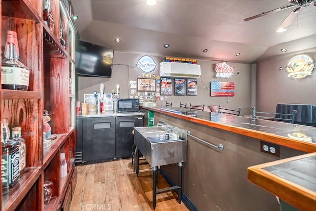 2575 Palomino Dr, Acton, CA 93510 - indoor wet bar featuring black microwave, light wood-style flooring, vaulted ceiling, ceiling fan, and recessed lighting