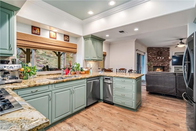2575 Palomino Dr, Acton, CA 93510 - kitchen with green cabinets, appliances with stainless steel finishes, crown molding, ceiling fan, and a peninsula