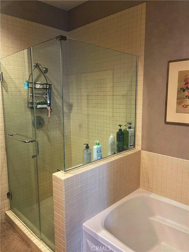 801 S Grand Ave Unit 1608, Los Angeles, CA 90017 - bathroom featuring a bath and a shower stall