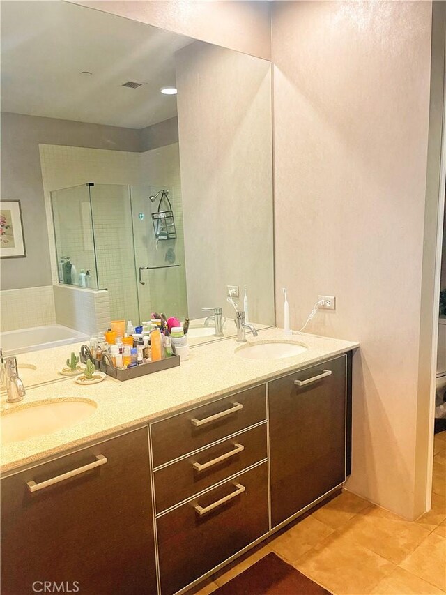 801 S Grand Ave Unit 1608, Los Angeles, CA 90017 - full bath featuring double vanity, a shower stall, a garden tub, and tile patterned flooring