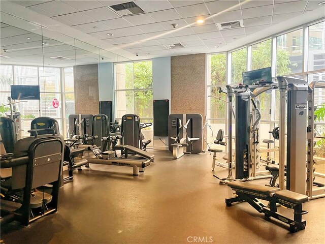 801 S Grand Ave Unit 1608, Los Angeles, CA 90017 - exercise room featuring floor to ceiling windows, healthy amount of natural light, and a drop ceiling