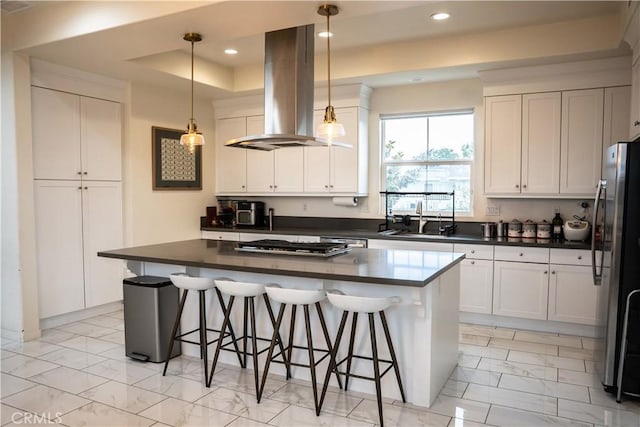 21125 Normandie Ave, Torrance, CA 90501 - kitchen with island exhaust hood, light marble finish floors, dark countertops, white cabinetry, and recessed lighting
