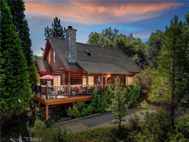 1415 Manzanita Way, Lake Arrowhead, CA 92352 - rear view of property featuring log siding, a chimney, a deck, and roof with shingles