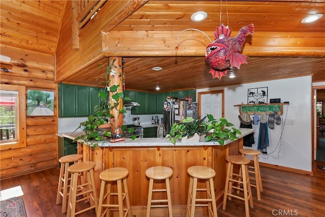 1415 Manzanita Way, Lake Arrowhead, CA 92352 - kitchen featuring appliances with stainless steel finishes, green cabinets, wood ceiling, dark wood-type flooring, and a kitchen bar