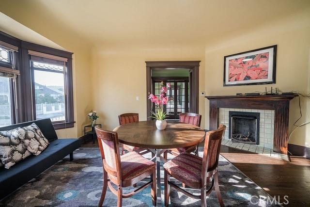 2109 Toberman St, Los Angeles, CA 90007 - dining area featuring wood finished floors and a tiled fireplace