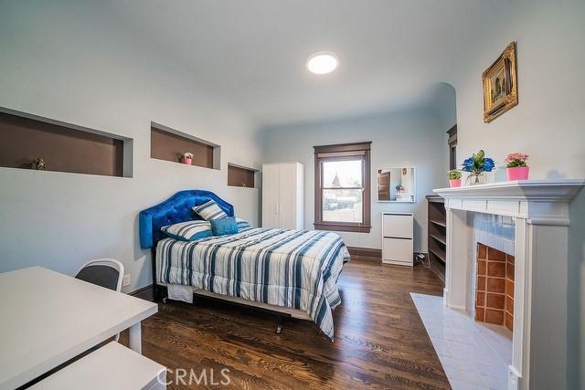 2109 Toberman St, Los Angeles, CA 90007 - bedroom with a premium fireplace and wood finished floors