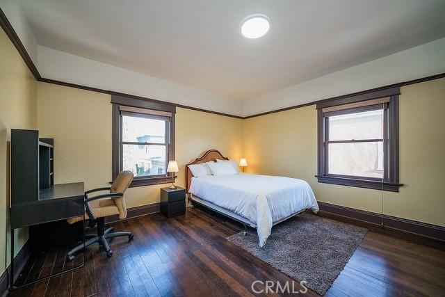 2109 Toberman St, Los Angeles, CA 90007 - bedroom with multiple windows, wood finished floors, and an office area