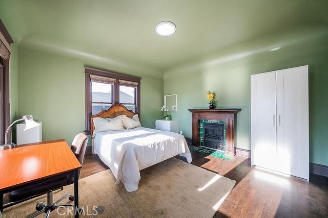 2109 Toberman St, Los Angeles, CA 90007 - bedroom with a fireplace with flush hearth and wood finished floors