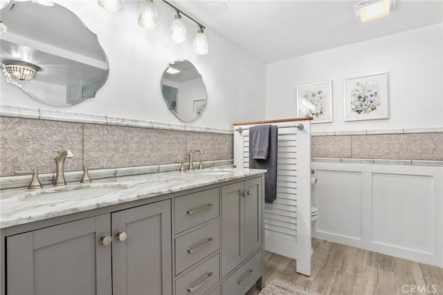 2722 E 20th St Unit 202, Signal Hill, CA 90755 - full bath with double vanity, wood finished floors, tile walls, and wainscoting