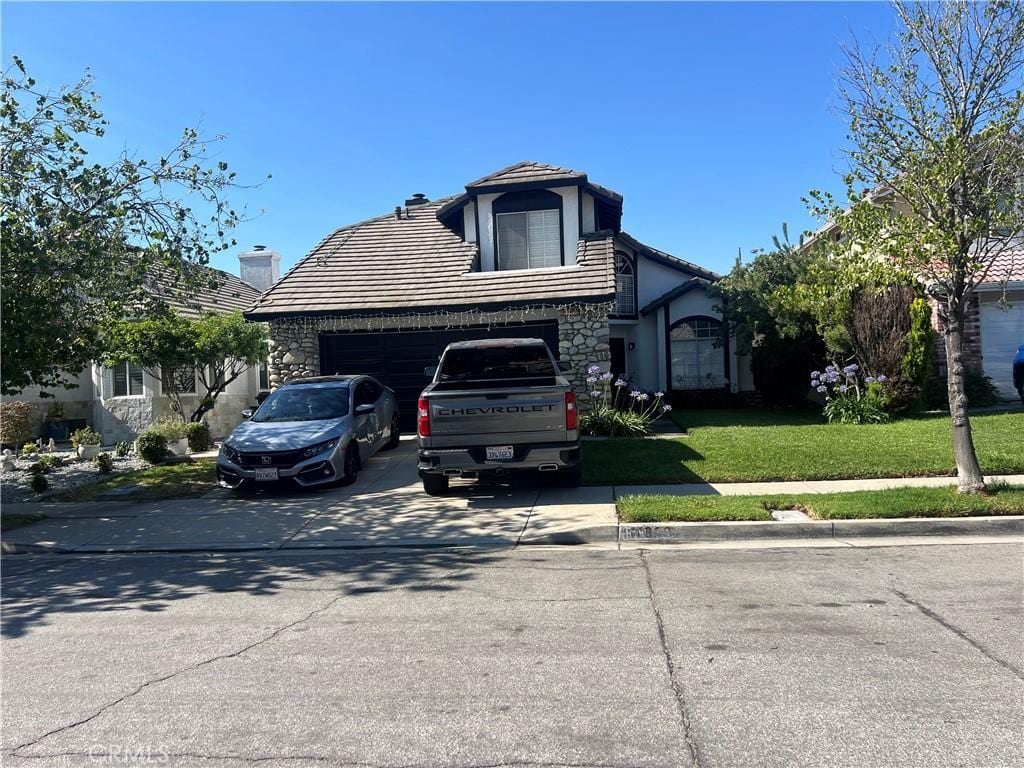 11839 Antler Peak Ct, Rancho Cucamonga, CA 91737 - view of front of house with concrete driveway, a tile roof, stucco siding, a front lawn, and an attached garage