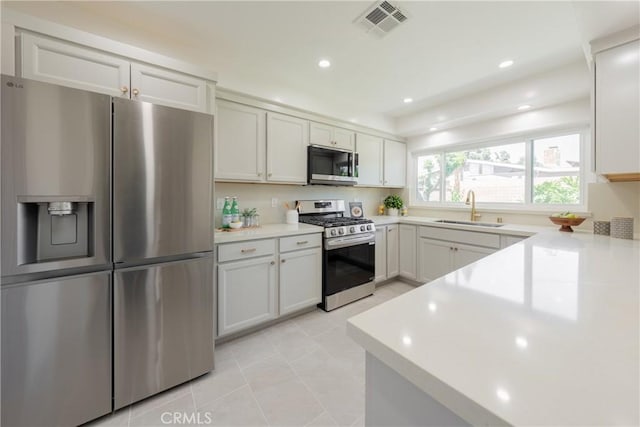 14314 De Alcala Dr, La Mirada, CA 90638 - kitchen with stainless steel appliances, light countertops, light tile patterned flooring, and recessed lighting