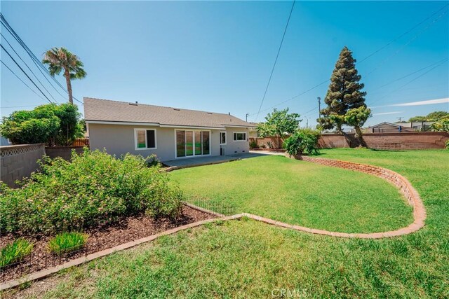 14314 De Alcala Dr, La Mirada, CA 90638 - rear view of house with a fenced backyard and stucco siding