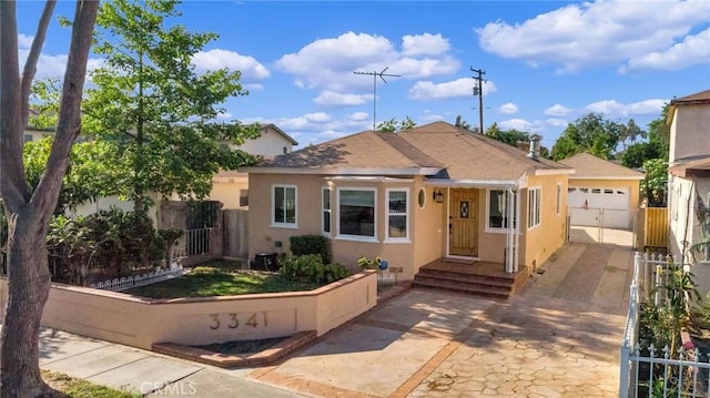 3341 Wisconsin Ave, South Gate, CA 90280 - bungalow with stucco siding, a garage, and driveway