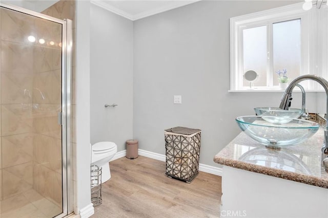 3341 Wisconsin Ave, South Gate, CA 90280 - bathroom featuring a shower stall, double vanity, ornamental molding, and wood finished floors