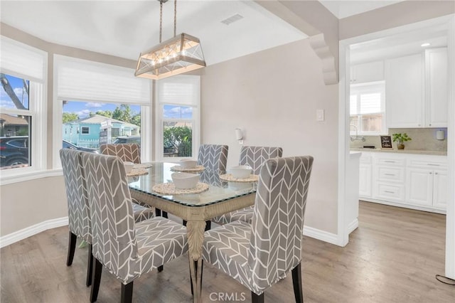 3341 Wisconsin Ave, South Gate, CA 90280 - dining space with baseboards and light wood-style floors