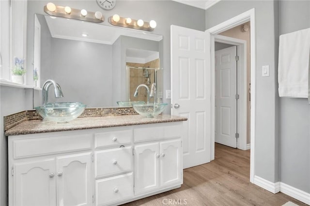 3341 Wisconsin Ave, South Gate, CA 90280 - full bathroom with crown molding, double vanity, a stall shower, and wood finished floors