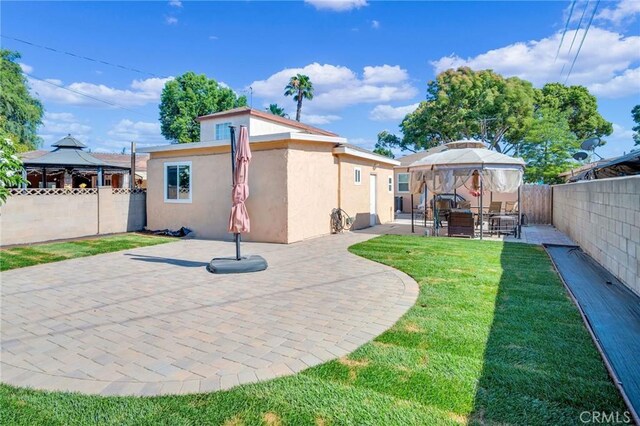 3341 Wisconsin Ave, South Gate, CA 90280 - rear view of property with a gazebo, stucco siding, a patio, and a fenced backyard