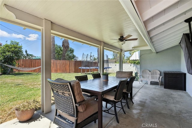 4220 Monticello Ave, Riverside, CA 92503 - fenced backyard featuring a trampoline, a patio, outdoor dining space, and ceiling fan
