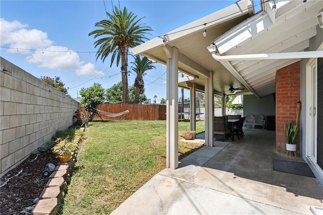 4220 Monticello Ave, Riverside, CA 92503 - fenced backyard with a patio, ceiling fan, and a trampoline