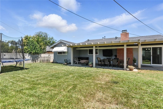 4220 Monticello Ave, Riverside, CA 92503 - back of property with a trampoline, a chimney, and a patio