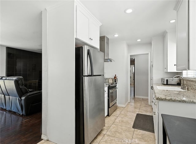 4220 Monticello Ave, Riverside, CA 92503 - kitchen featuring appliances with stainless steel finishes, wall chimney range hood, white cabinetry, recessed lighting, and light stone counters