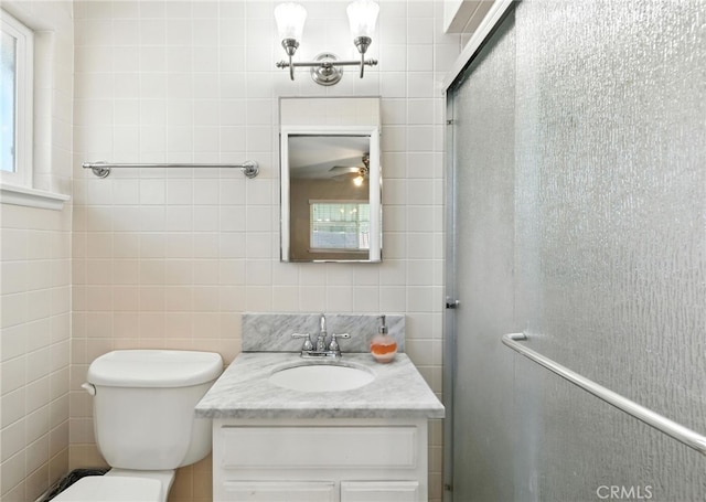 4220 Monticello Ave, Riverside, CA 92503 - bathroom featuring vanity, tile walls, healthy amount of natural light, and a shower with shower door