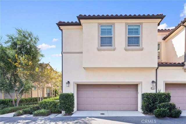 26 Prominence, Lake Forest, CA 92630 - view of front of home with an attached garage, stucco siding, and a tile roof