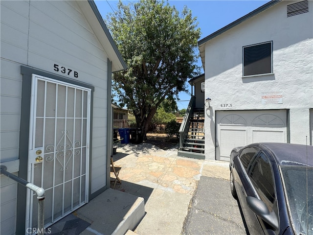 537 San Francisco Ave, Pomona, CA 91767 - view of side of home featuring stairs and an attached garage