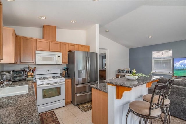177 Jerome Ct, Nipomo, CA 93444 - kitchen featuring white appliances, lofted ceiling, a breakfast bar, a kitchen island, and dark stone counters