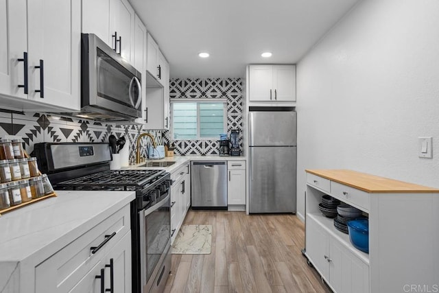 803 S Pacific St Unit 1, Oceanside, CA 92054 - kitchen featuring stainless steel appliances, light wood finished floors, tasteful backsplash, white cabinetry, and recessed lighting