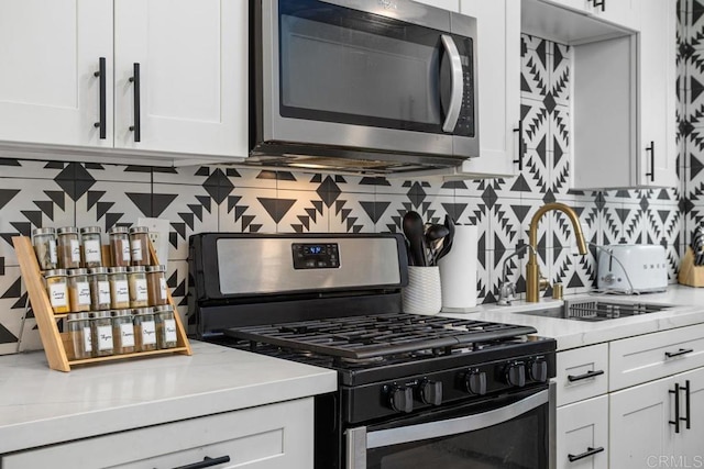803 S Pacific St Unit 1, Oceanside, CA 92054 - kitchen featuring stainless steel appliances, light countertops, backsplash, and white cabinetry