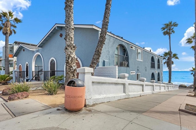 803 S Pacific St Unit 1, Oceanside, CA 92054 - view of property exterior featuring a fenced front yard, stucco siding, and a water view