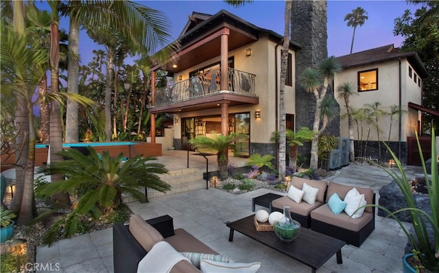 3908 Channel Pl, Newport Beach, CA 92663 - rear view of property with a balcony, an outdoor hangout area, stucco siding, and a patio area