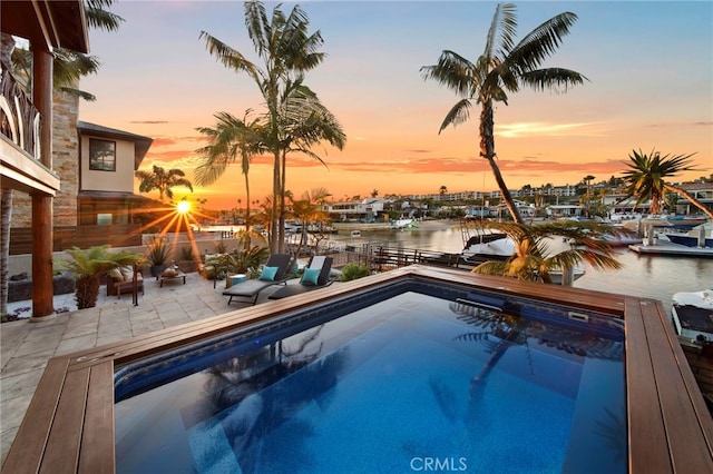 3908 Channel Pl, Newport Beach, CA 92663 - pool at dusk with a water view and a patio area