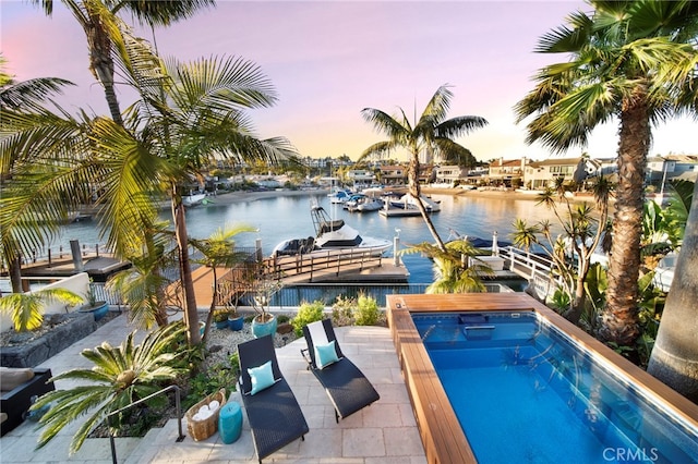 3908 Channel Pl, Newport Beach, CA 92663 - pool at dusk with a water view, an outdoor pool, and a hot tub