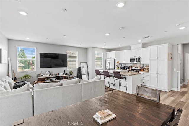 7020 Turin Pl, Eastvale, CA 92880 - living room featuring plenty of natural light, light wood-type flooring, and recessed lighting